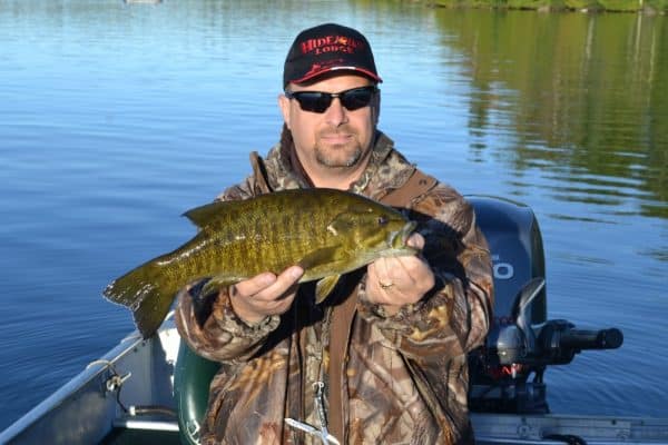 A Happy Angler With A Smallmouth Bass At Hideaway Lodge