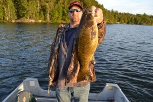 A Happy Angler With A Smallmouth Bass At Hideaway Lodge